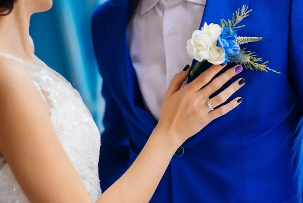 Костюм жениха в синем цвете с бутоньеркой, крупный план